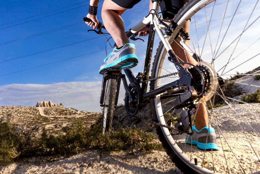 The man's foot with a bicycle outdoor cycling interval training