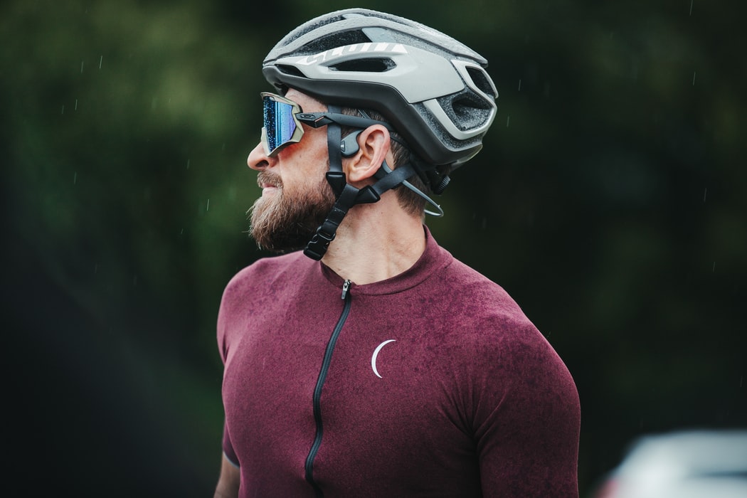 a man wears cycling helmets